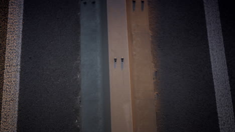 Closeup-car-driving-highway-in-morning.-Freeway-crash-barrier-view-drone-shot.