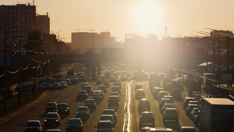 Car-traffic-jam-on-highway.-City-transportation-on-rush-hour-sunny-evening.