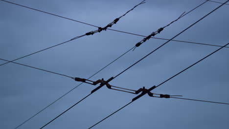 Closeup-trolleybus-wires-cloudy-sky.-Electrical-cables-net-for-high-voltage