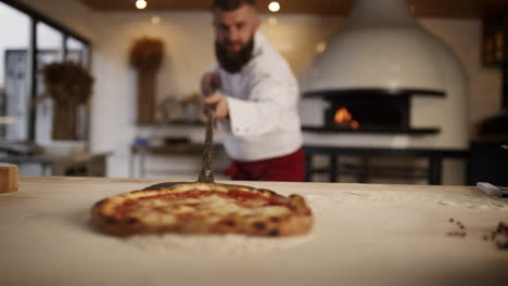 Italian-chef-making-pizza-in-restaurant.-Pastry-cook-taking-out-food-in-oven.