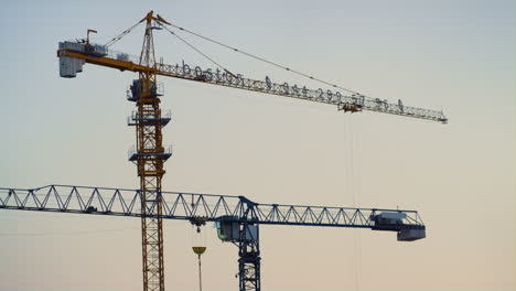 High-building-cranes-clear-evening-sky-drone-shot.-Metropolis-city-development