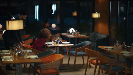 Multiracial-couple-going-out-on-romantic-dinner-date-in-night-restaurant-cafe.