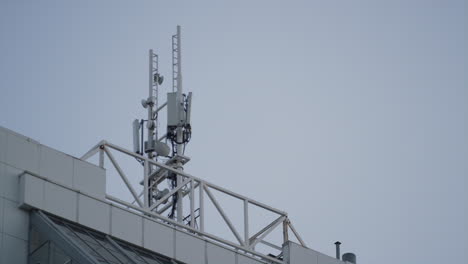 Communication-antenna-building-rooftop-drone-shot.-High-frequency-interference