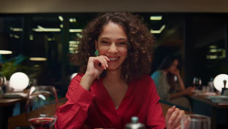 Laughing-woman-looking-camera-on-romantic-dinner-date-in-fancy-restaurant-cafe.