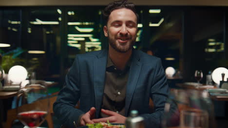 Emotional-man-talking-date-on-dinner.-Guy-gesturing-hands-on-restaurant-table.