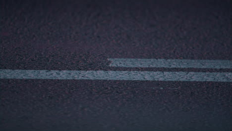 Road-double-lines-marking-beginning-on-asphalt-highway-closeup.-Traffic-control.