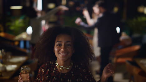 African-american-girl-dancing-on-friends-party.-Fancy-woman-holding-drink-glass.