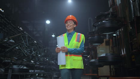 Cheerful-woman-supervisor-walking-at-digital-manufacturing-company-warehouse.