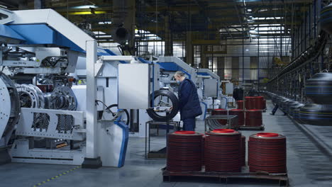 Workers-at-tyre-manufacture-inspecting-rubber-product-quality-working-process
