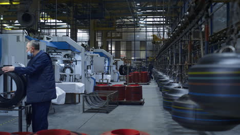 Tyre-production-storage-employees-working-in-factory-carrying-rubber-product