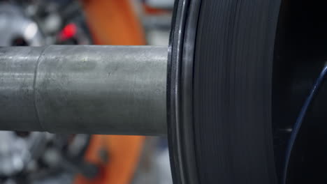 Tyre-production-machine-detail-rotating-in-modern-robotic-factory-close-up