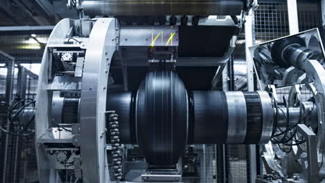 Robotic-tire-manufacturing-machine-stamping-rubber-tape-in-modern-manufacture