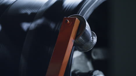Closeup-rubber-tyre-tape-manufacturing-process-at-industrial-manufacture-concept