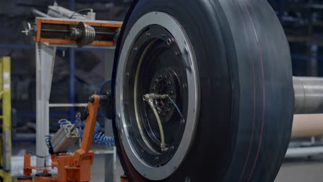 Tyre-production-machine-rotating-with-new-car-rubber-tire-at-industrial-factory