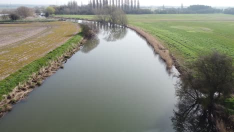 Low-aerial-drone-shot-of-the-River-Stour-in-Kent,-England