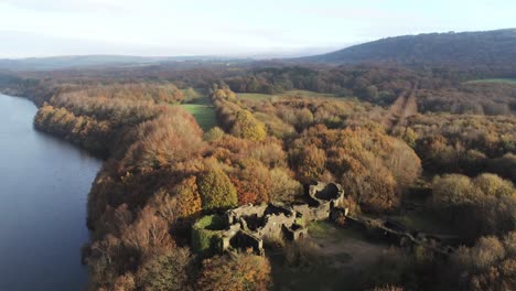 Liverpool-castle-replica-ruins-in-Autumn-Rivington-woodland-nature-reservoir-aerial-establishing-view