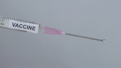 Medical-Syringe-On-White-Background-Flick-By-A-Physician,-Close-Up-Shot