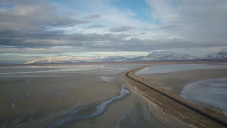 A-drone-explores-the-coast-line-and-open-road-to-Antelope-Island-in-The-Great-Salt-Lake-of-Utah