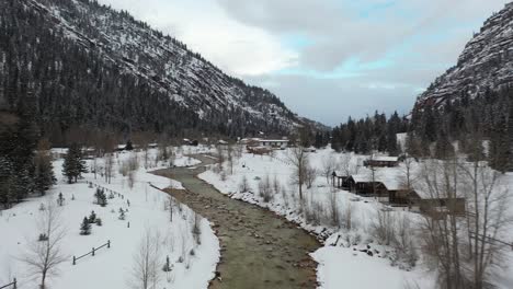 Winter-landscape-of-Ouray-valley,-Colorado,-snow-capped-fields-and-hills-on-cold-morning,-drone-shot