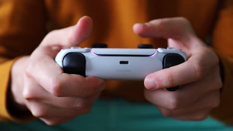Close-up-of-hands-playing-with-Playstation-5-controller