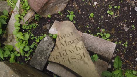 Close-up-of-a-broken-old-gravestone-in-Wales