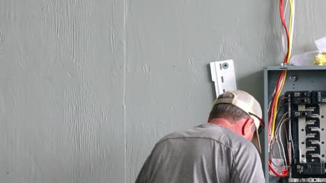 Technician-using-a-drill-to-install-the-support-bracket-for-the-power-system-control-station