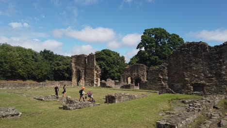 A-wide-shot-of-people-walking-around-the-Abbey-ruins