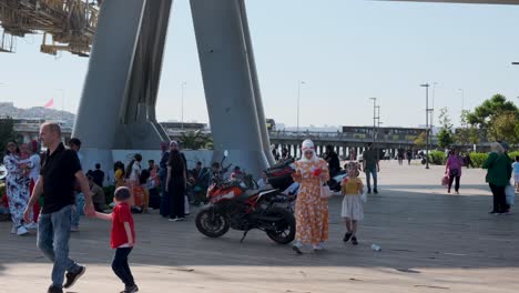 Toursit-and-local-sitting-under-The-Bosphorus-Bridge-known-officially-as-the-15-July-Martyrs-Bridge,-istanbul,-Tureky-on-20