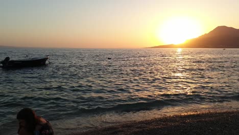 A-small-ship-lying-at-anchor-in-the-sunset