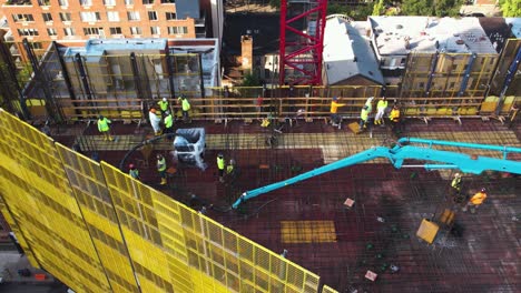 People-working-on-a-rooftop-construction-site-in-Brooklyn,-NY,-USA---Aerial-view