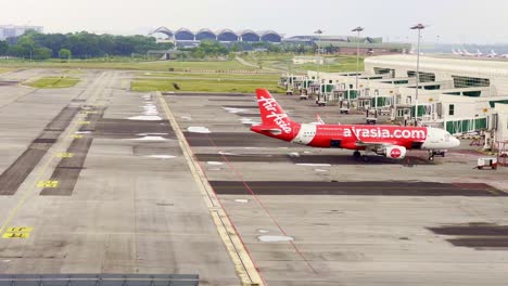 High-angle-shot-of-a-single-Air-Asia-plane-at-Kuala-Lumpur-International-Airport-in-Malaysia-at-daytime