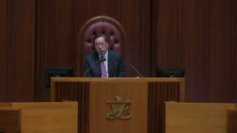 Hong-Kong-Legislative-Council-President,-Andrew-Leung,-is-seen-listening-and-sitting-on-the-president-elected-chair-during-a-meeting-at-the-Legislative-Council's-main-chamber-in-Hong-Kong