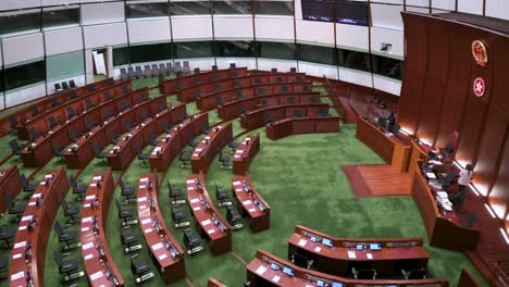 Overhead-shot-view-of-an-empty-Legislative-Council-main-chamber-as-the-People's-Republic-of-China-and-Hong-Kong-Special-Administrative-Region-emblems-seen-above-the-presidential-elected-chair