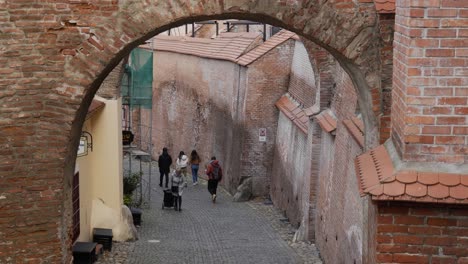 People-Walking-Along-The-Narrow-Old-Street