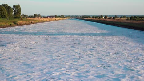 White-foaming-water-exiting-the-tidal-power-station-near-Mont-Saint-Michel