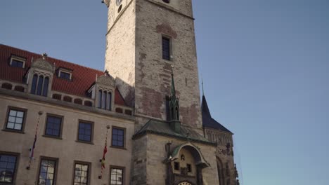 Old-Town-Hall-Tower-in-Prague,-people-watching-astronomical-clock-of-orloj,-tilting-down-view