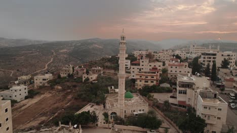 Aerial-camera-footage-of-a-city-with-a-mosque-and-surrounding-hills-in-Jerusalem-Drone