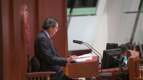 Hong-Kong-Legislative-Council-President,-Andrew-Leung,-is-seen-sitting-on-the-president-elected-chair-during-a-meeting-at-the-Legislative-Council's-main-chamber-in-Hong-Kong