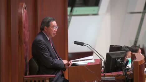 Hong-Kong-Legislative-Council-President,-Andrew-Leung,-is-seen-sitting-on-the-president-elected-chair-during-a-meeting-at-the-Legislative-Council's-main-chamber-in-Hong-Kong