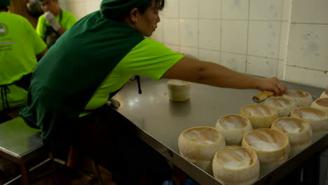 Thailand,-Bangkok---13-August-2022:-Woman-worker-preparing-the-shell-for-coco-jelly,-famous-thai-street-food,-extracting-coconut-pulp-using-scraper