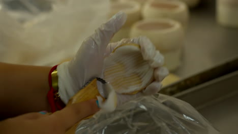 Thailand,-Bangkok---13-August-2022:-Close-up-unrecognizable-worker-extracting-coconut-pulp-from-the-top-shell-using-scraper