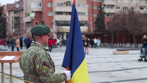 Solider-with-flag-stands-at-attention,-National-Day-Parade,-Miercurea-Ciuc,-Romania