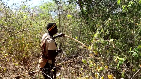 Hadzabe-tribe-chief-making-noise-with-a-branch-to-distract-his-prey-before-the-hunt