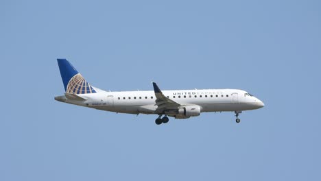 Large-airliner-with-passengers-on-blue-sky-is-landing-on-landing-strip-at-airport-on-sunny-summer-day