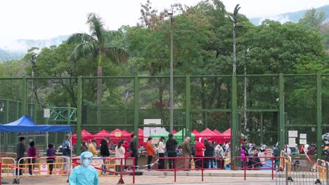 Chinese-citizens-queue-in-line-to-be-tested-for-Covid-19-coronavirus-outside-a-building-placed-under-lockdown-after-a-large-number-of-residents-tested-positive-in-Hong-Kong