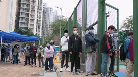 Los-Ciudadanos-Hacen-Cola-Para-Hacerse-La-Prueba-Del-Coronavirus-Covid-19-Fuera-De-Un-Edificio-Cerrado-Después-De-Que-Un-Gran-Número-De-Residentes-Dieron-Positivo-En-Hong-Kong