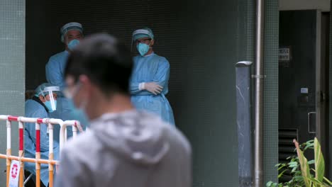 Chinese-health-workers-dressed-in-PPE-suits-are-seen-inside-an-area-under-lockdown-as-residents-go-through-a-Covid-19-Coronavirus-mass-testing-after-a-large-number-of-residents-tested-positive