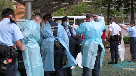 Police-officers-wearing-personal-protective-equipment-outside-a-building-placed-under-lockdown-at-a-public-housing-complex-after-a-large-number-of-residents-tested-positive-in-Hong-Kong