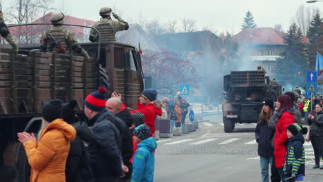 Military-transport-vehicles-carry-soldiers-in-National-Day-Parade,-Miercurea-Ciuc,-Romania