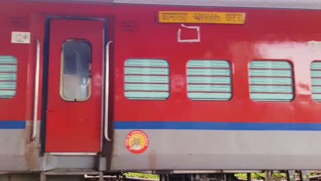 indian-passenger-express-train-crossing-station-on-track-at-evening-from-flat-angle-video-is-taken-at-kamakhya-railway-station-assam-india-on-May-22-2022